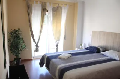 a bedroom with a bed and a large window at Lilas' Private Accommodation in Vila do Bispo
