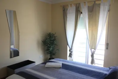 a bedroom with a large bed and a window at Lilas' Private Accommodation in Vila do Bispo