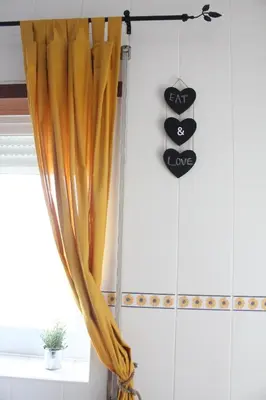 a curtain hanging in a room with a window at Lilas' Private Accommodation in Vila do Bispo