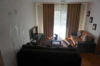 a living room with a couch and a television at Jardim das Madalenas in Funchal