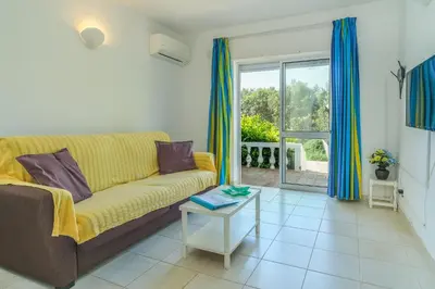 a living room with a couch and a table at Casas do Ramalhete in Luz