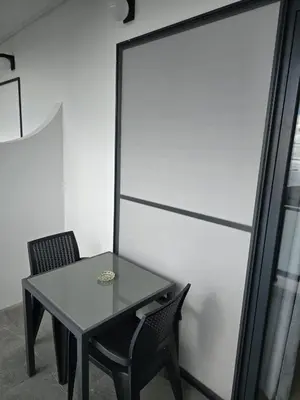 a table and two chairs sitting next to a window at AL Moniz in Machico