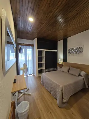 a bedroom with a bed and a television in it at AL Moniz in Machico