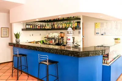 a bar with two stools at a blue counter at Amparo in Machico