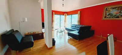 a living room with a black couch and a red wall at Villa Luz - Family House Vacations- Large Private Outdoor Area in Santa Cruz
