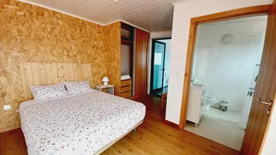 a bedroom with a bed and a bathroom with a shower at Villa Luz - Family House Vacations- Large Private Outdoor Area in Santa Cruz