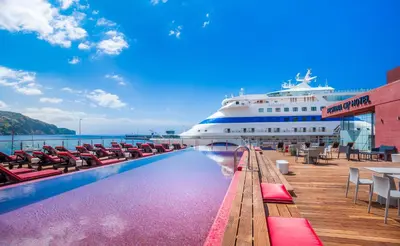 a cruise ship sitting next to a swimming pool at Pestana CR7 Funchal in Funchal