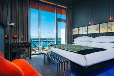 a bedroom with a bed with a view of the ocean at Pestana CR7 Funchal in Funchal