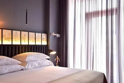 a bedroom with a bed and a large window at Pestana CR7 Funchal in Funchal