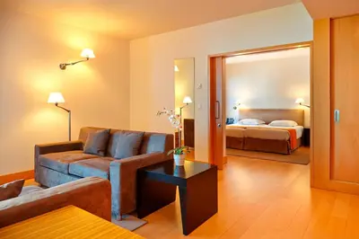 a living room with a couch and a bed at Golden Residence Hotel in Funchal