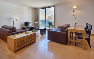 a living room with a couch and a table at Golden Residence Hotel in Funchal