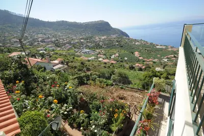 a view from the balcony of a house with flowers at Casa Daniela in Calheta