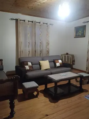 a living room with a couch and a coffee table at Casa Daniela in Calheta