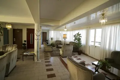 a large living room with chairs and a lobby at Hotel Sirius in Funchal