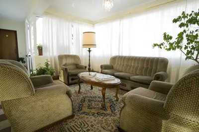 a living room with couches and chairs and a table at Hotel Sirius in Funchal