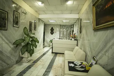 a room with a waiting room with a couch and a sink at Hotel Sirius in Funchal