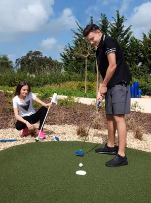 a man and a woman playing a game of golf at Aldeia Azul Resort in Lagos