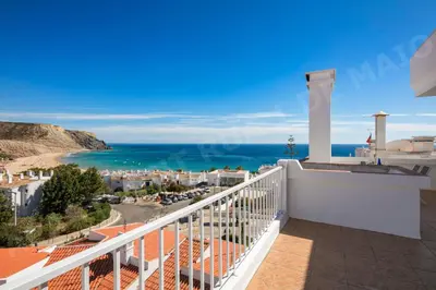 a balcony with a view of the ocean at Maio Apartment in Luz