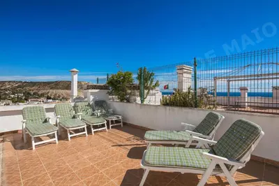 a row of chairs sitting on top of a roof at Maio Apartment in Luz