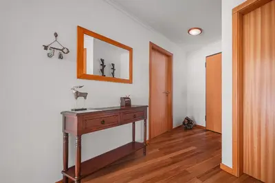 a room with a wooden table and a mirror at Beachfront Penthouse with Panoramic Ocean-View Terrace VIP Baia in Machico