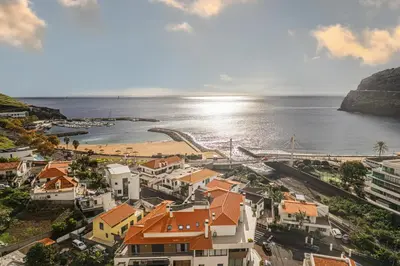 an aerial view of a town with a beach at Beachfront Penthouse with Panoramic Ocean-View Terrace VIP Baia in Machico