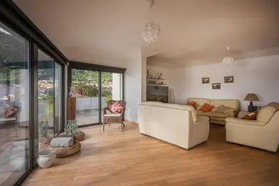 a living room with two white couches and a living room with glass doors at Beachfront Penthouse with Panoramic Ocean-View Terrace VIP Baia in Machico