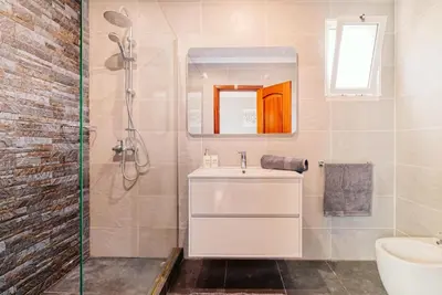a bathroom with a sink and a shower at Vip VI - Sea view apartment in Caniço