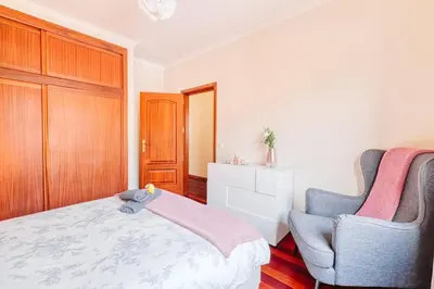 a bedroom with a bed and two chairs at Vip VI - Sea view apartment in Caniço