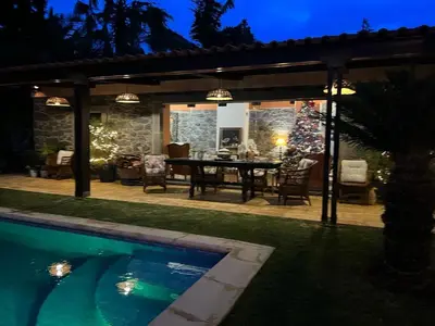 a villa with a swimming pool at night at Casa do Poço Funchal in Funchal