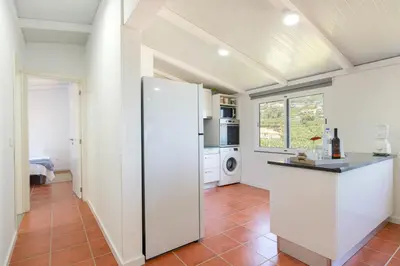 a kitchen with white walls and a refrigerator at Apartment Annie 2 in Arco da Calheta