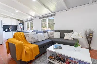 a living room with a couch and a table at Apartment Annie 2 in Arco da Calheta