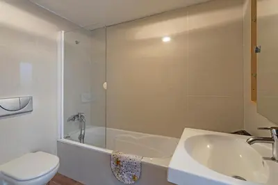 a bathroom with a tub and a sink and a toilet at Casa do Lugar de Baixo in Ponta do Sol