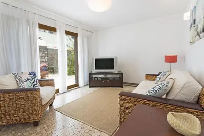 a living room with two couches and a television at Casa do Lugar de Baixo in Ponta do Sol