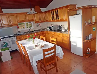 a kitchen table with a white table cloth on it at Villa Catanho in Funchal