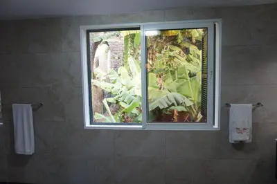 a bathroom with a shower with a glass door at Villa Catanho in Funchal