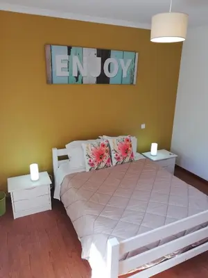 a bedroom with a large bed with two night stands at FX Pena in Funchal