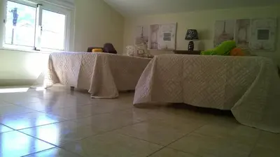 two tables with white table cloths on them in a room at Apartamento Teixeira 2 in Arco da Calheta