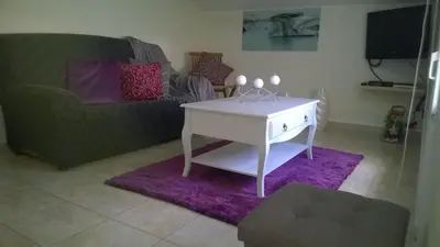 a living room with a white table and a couch at Apartamento Teixeira 2 in Arco da Calheta