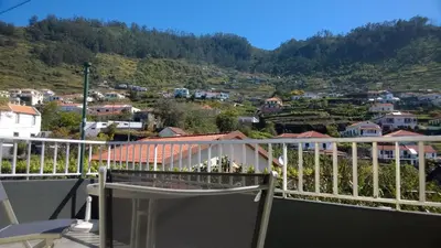 a balcony with a view of a city at Apartamento Teixeira 2 in Arco da Calheta