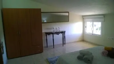 a bedroom with a bed and a dresser and a mirror at Apartamento Teixeira 2 in Arco da Calheta