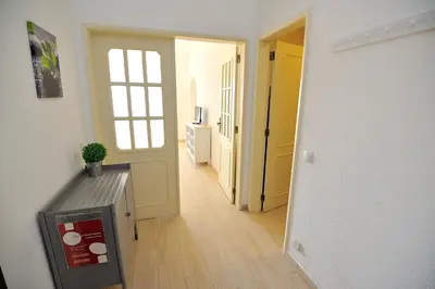 a room with a hallway with a door and a table at Sunhouse in Luz