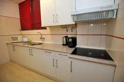 a small kitchen with a sink and a microwave at Sunhouse in Luz