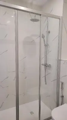 a shower with a glass door in a bathroom at Sunhouse in Luz