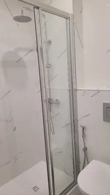 a shower stall in a bathroom with a toilet at Sunhouse in Luz