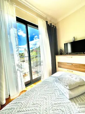 a bedroom with a bed and a large window at Plaza Charming Flat in Santa Cruz