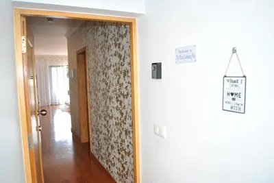 a hallway with a floral wall paper and a door at Plaza Charming Flat in Santa Cruz