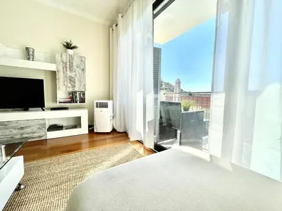 a living room with a large window and a television at Plaza Charming Flat in Santa Cruz
