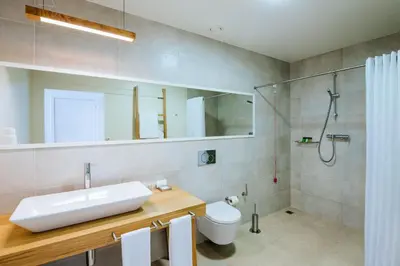 a bathroom with a sink and a shower and a toilet at Vila Baleira Village in Porto Santo