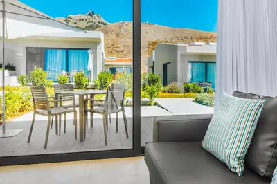 a balcony with a table and chairs on a patio at Vila Baleira Village in Porto Santo
