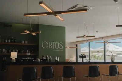 a dining room with tables and chairs in a building at Vila Baleira Village in Porto Santo